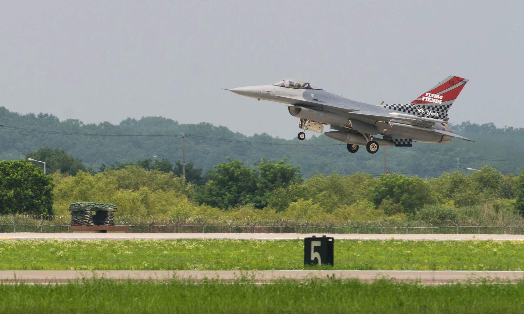 The 36th Fight Squadron Flying Fiends centennial F-16 Fighting Falcon takes off from Osan Air Base, Republic of Korea, July 19, 2017. U.S. Air Force Col. Andrew P. Hansen, 51st Fighter Wing commander, flew the freshly painted jet for the first time during his final flight at Osan. (U.S. Air Force photo by Staff Sgt. Alex Fox Echols III)