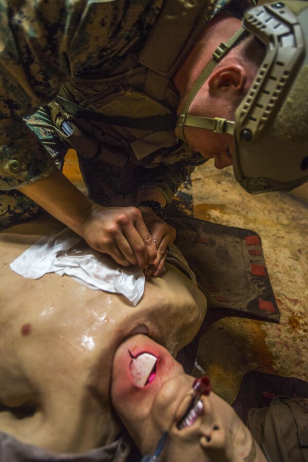 A Marine with 3rd Reconnaissance Battalion, 3rd Marine Division, III Marine Expeditionary Force inserts a needle into a simulated casualty during the Tactical Combat Casualty Care course at the Tactical Medical Simulation Center, Camp Hansen, Okinawa, Japan, July 13, 2017. The course included hands-on medical training and, on the final day, a realistic scenario designed for the trainee to react under pressure. (U.S. Marine Corps photo by Lance Cpl. Andy Martinez)
