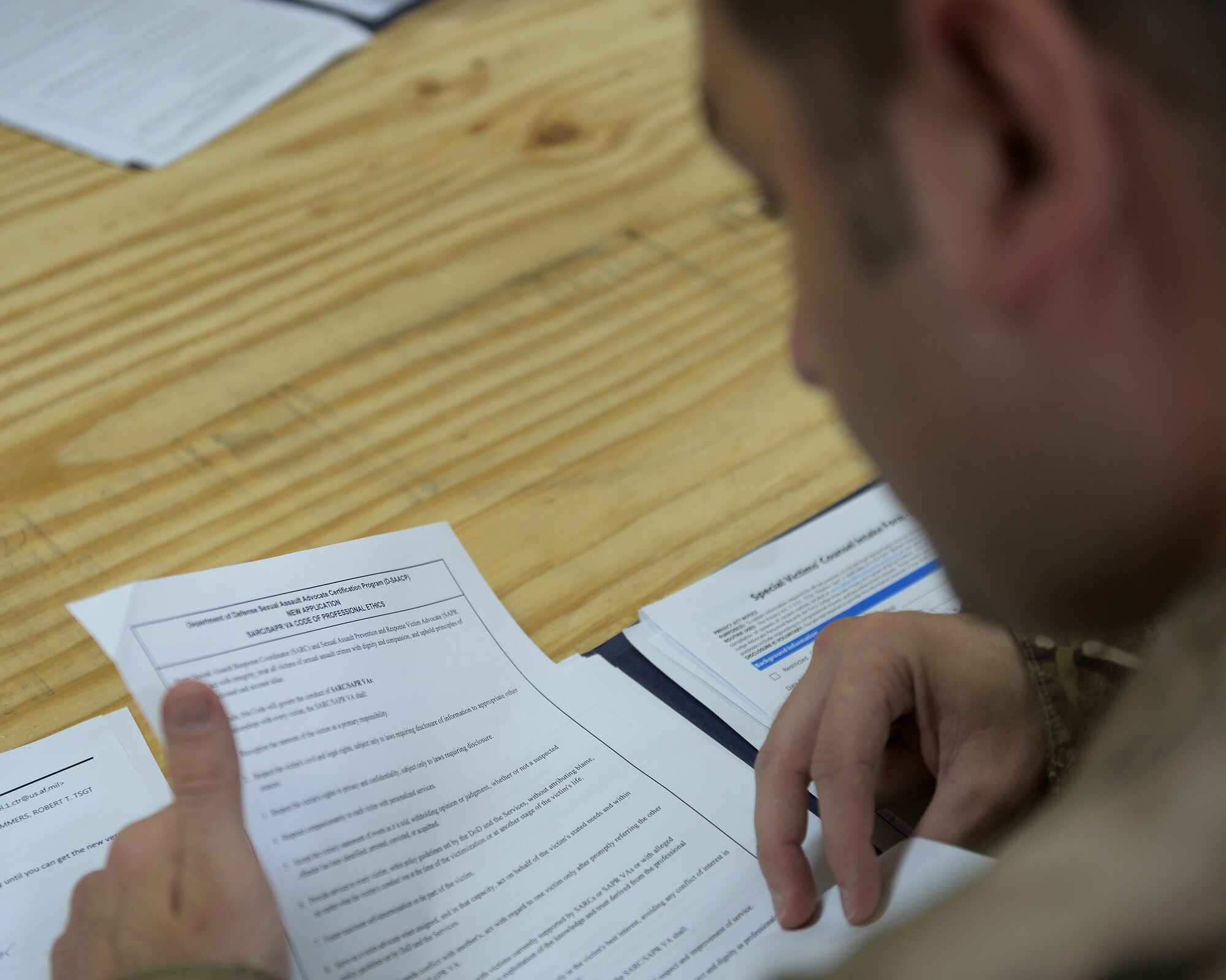 Tech. Sgt. Robert Summers studies the Sexual Assault Prevention and Response Victim Advocate Code of Professional Ethics while participating in training at an undisclosed location, East Africa, July 13, 2017. The guidelines help govern the actions of victim advocates to ensure the most professional assistance is given to victims of sexual assault. (U.S. Air Force photo by Senior Airman Jimmie D. Pike)