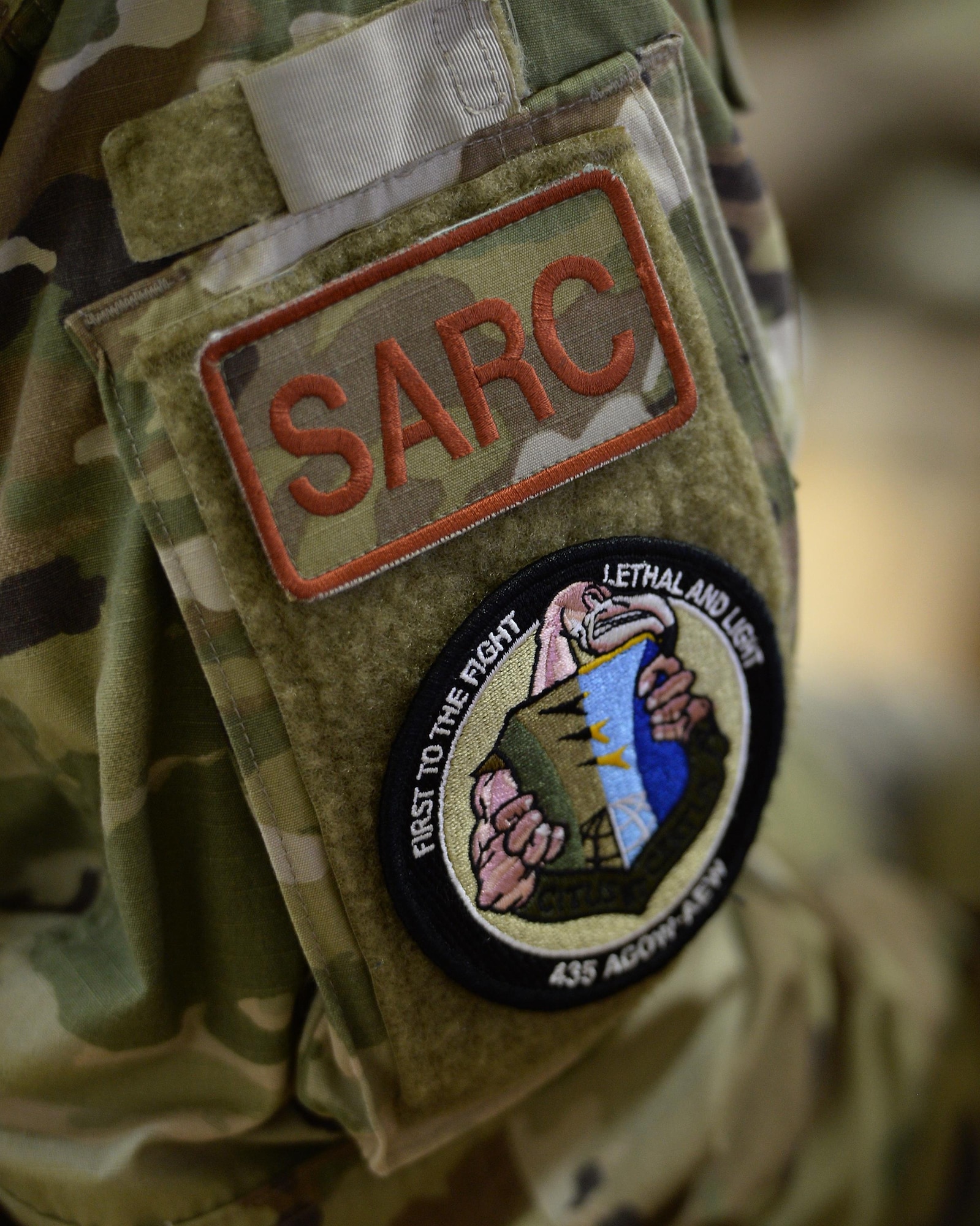 Patches depicting “SARC”, Sexual Assault Response Coordinator, and the 435th Air Expeditionary Wing/Air Ground Operations Wing’s flamingo mascot, stick to arm of 1st Lt. DeAndrea Jones, 435th AEW SARC. Jones travels to expeditionary locations in Africa under the 435th AEW to provide training and assistance to victim advocates, allowing victims of sexual assault to receive the help they need while deployed. (U.S. Air Force photo by Senior Airman Jimmie D. Pike)