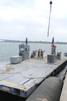 Soldiers of the 331st Transportation Company (Causeway) assemble a Modular Warping Tug (MWT) at the Port of San Diego in preparation to construct a Modular Causeway System (MCS) during Big LOTS West 17.