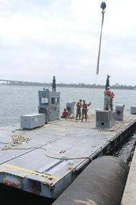 Soldiers of the 331st Transportation Company (Causeway) assemble a Modular Warping Tug (MWT) at the Port of San Diego in preparation to construct a Modular Causeway System (MCS) during Big LOTS West 17.