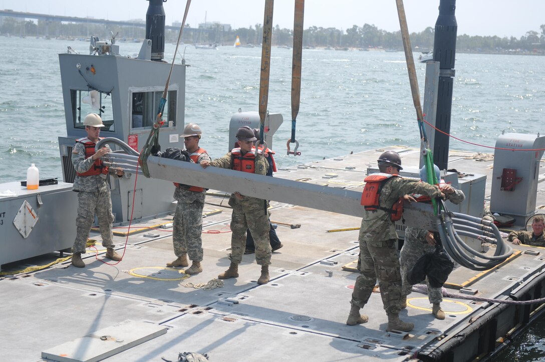 Soldiers of the 331st Transportation Company (Causeway) assemble a Modular Warping Tug (MWT) at the Port of San Diego in preparation to construct a Modular Causeway System (MCS) during Big LOTS West 17.