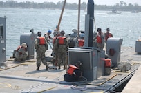 Soldiers of the 331st Transportation Company (Causeway) assemble a Modular Warping Tug (MWT) at the Port of San Diego in preparation to construct a Modular Causeway System (MCS) during Big LOTS West 17.
