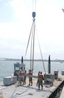 Soldiers of the 331st Transportation Company (Causeway) assemble the beam portion of a Modular Warping Tug (MWT) at the Port of San Diego in preparation to construct a Modular Causeway System (MCS) during Big LOTS West 17.