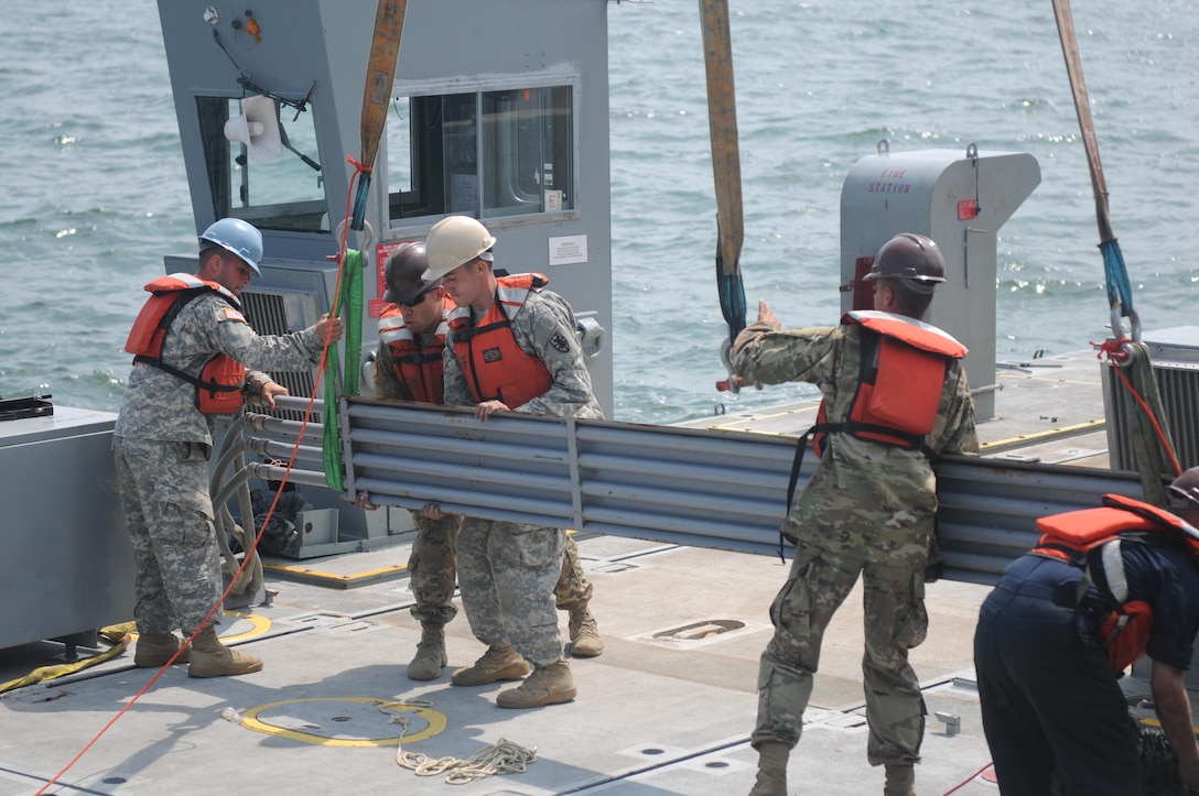 Soldiers of the 331st Transportation Company (Causeway) assemble a Modular Warping Tug (MWT) at the Port of San Diego in preparation to construct a Modular Causeway System (MCS) during Big LOTS West 17.