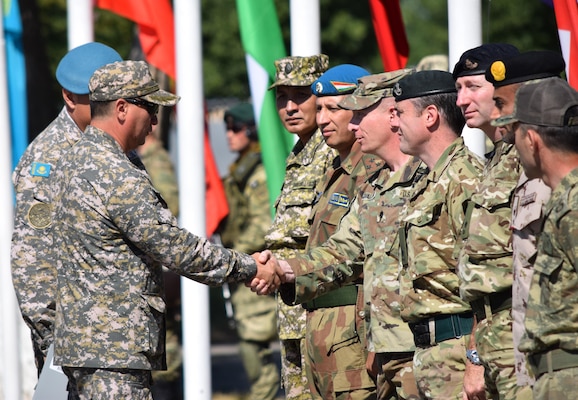 Maj. Gen. Murat Bektanov, Kazakhstan Land Forces commander, greets representatives from each nation participating in Exercise Steppe Eagle 17 during the opening ceremony July 22, 2017, at Illisky Training Center, Kazakhstan. (U.S. Army photo by Capt. Desiree Dillehay, 149th Military Engagement Team)