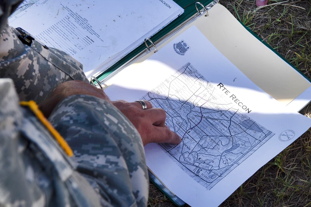 South Carolina Army National Guard members review a recon map preparing for the Spur Ride at McCrady Training Center in Eastover, S.C., July 14, 2017. The soldiers are assigned to the South Carolina Army National Guard’s Headquarters Company, 4th Battalion, 118th Infantry Battalion. The training tests the soldiers' skills in weapons, maintenance, call for fire, react to contact and medical tasks. Army National Guard photo by Spc. Chelsea Baker