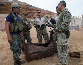 SAN LORENZO ISLAND, Peru (July 18, 2017) Sailors assigned to Explosive Ordnance Disposal Mobile Unit 1 and Peruvian special forces inspect the damage done by a water disruption charge during a demolition training exercise as part of UNITAS 2017. UNITAS is an annual, multi-national exercise that focuses on strengthening our existing regional partnerships and encourages establishing new relationships through the exchange of maritime mission-focused knowledge and expertise during multinational training operations. (U.S. Navy photo by Mass Communication Specialist 2nd Class Bill Dodge/Released)