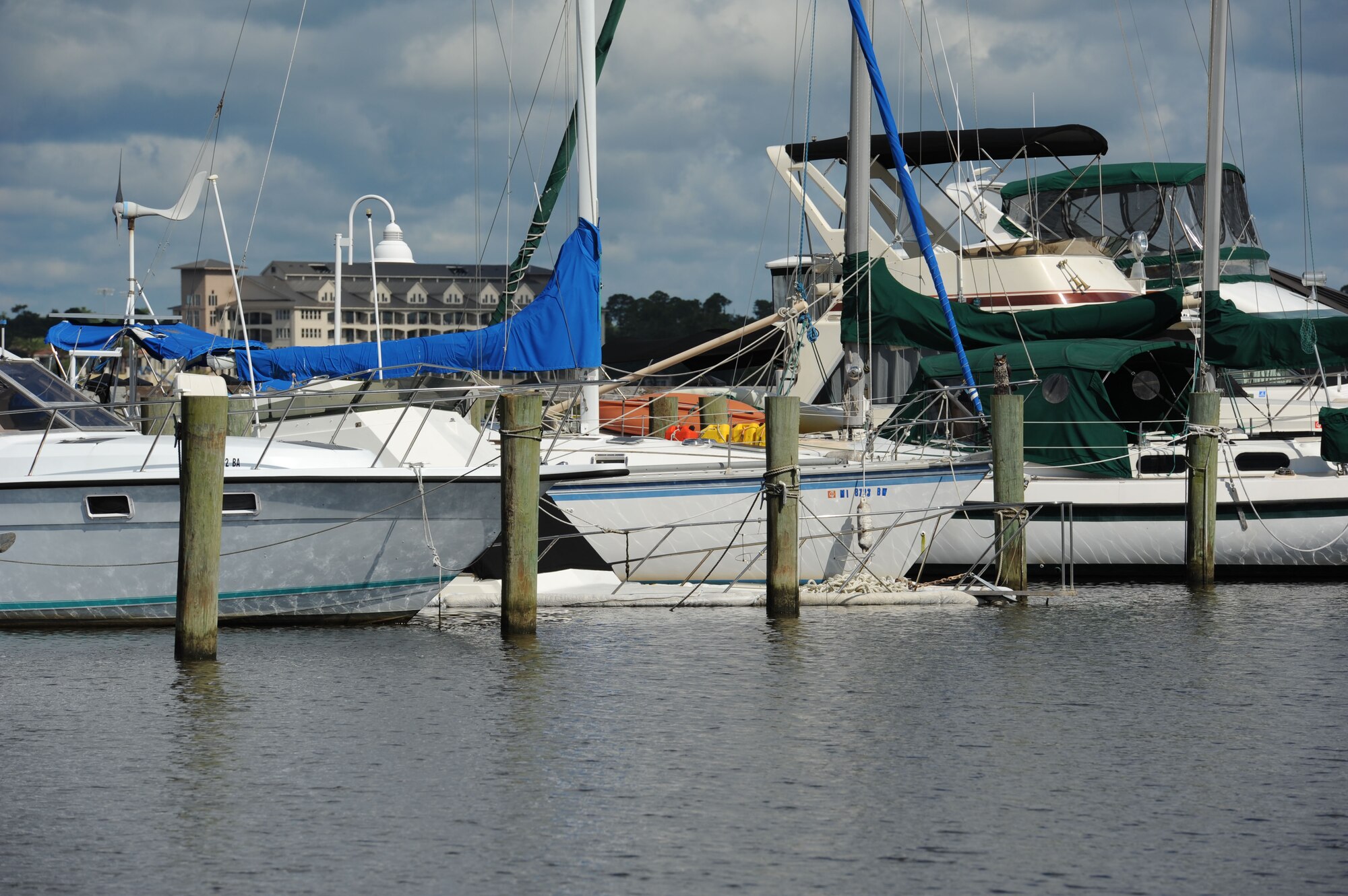 A privately-owned boat sits at the bottom of the marina while docked July 19, 2017, on Keesler Air Force Base, Miss. Several agencies, including members of Keesler Outdoor Recreation, Coast Guard Mobile Sector Incident Management Division, Mobile, Al., and Tow-Boat U.S. Biloxi, gathered to ensure appropriate guidelines and safety procedures were followed prior to retrieving the boat. (U.S. Air Force photo by Kemberly Groue)