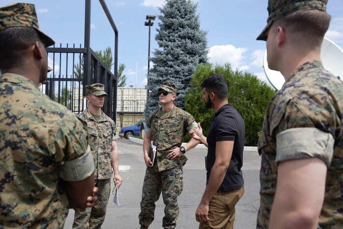 U.S. Marines and sailor with Black Sea Rotational Force 17.1 and Marine Rotational Force Europe 17.1 tour the embassy compound with the assistant regional security officer during an embassy reinforcement exercise in Chisinau, Moldova, July 15, 2017. Embassy reinforcement exercises improve emergency preparedness. 