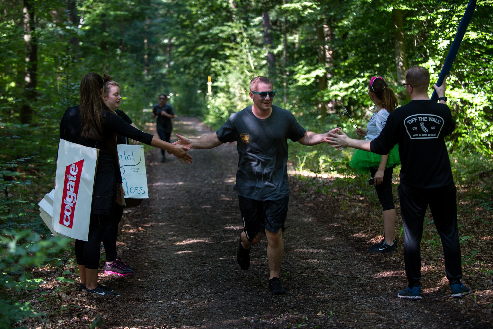 Tooth Slothy, a team of 86th Dental Squadron Airmen, cheer on opposing teams during the annual Mudless Mudder on Ramstein Air Base, Germany, July 21, 2017. The 5 kilometer race brought members from all over the 86th Airlift Wing to promote camaraderie and build resilience. (U.S. Air Force photo by Senior Airman Devin Boyer)