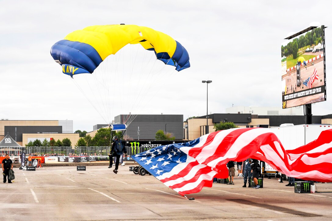 Retired Navy SEAL Jim Woods, a member of the U.S. Navy Parachute Team, “The Leap Frogs,” lands in the drop zone during a skydiving demonstration at the Summer X Games in Minneapolis, July 13, 2017. The Leap Frogs are based in San Diego and perform aerial parachute demonstrations around the nation in support of Naval Special Warfare and recruiting. Navy photo by Petty Officer 3rd Class Kelsey L. Adams