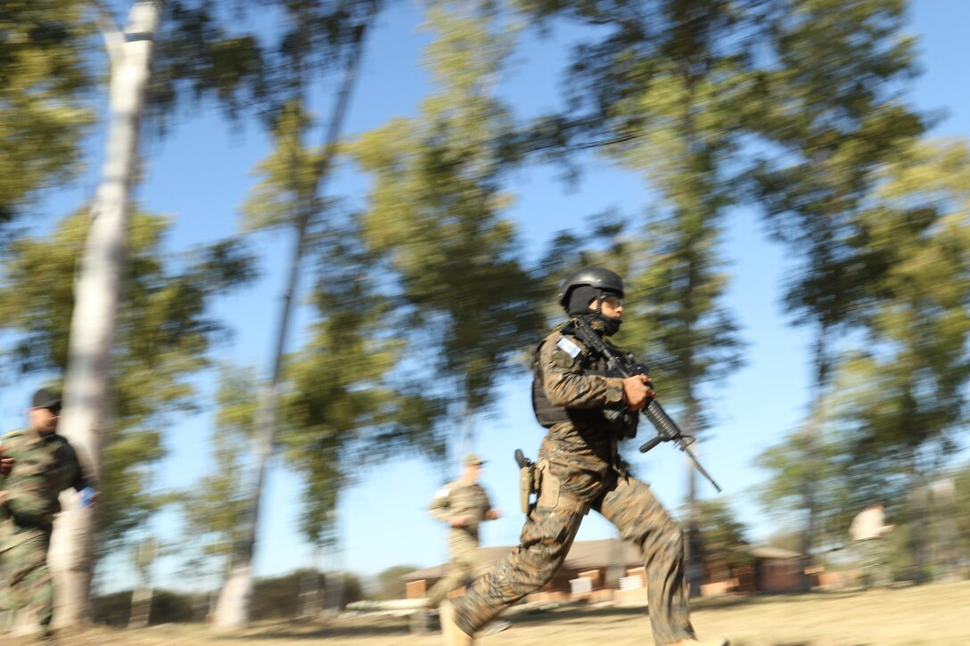 A competitor from Team Guatemala races toward his first target during a shooting event July 20, 2017, during Fuerzas Comando in Vista Alegre, Paraguay. Fuerzas Comando helps Guatemalan forces share and contribute to lasting stability and security in the Southern Hemisphere. (U.S. Army photo by Sgt. Joanna Bradshaw/Released)