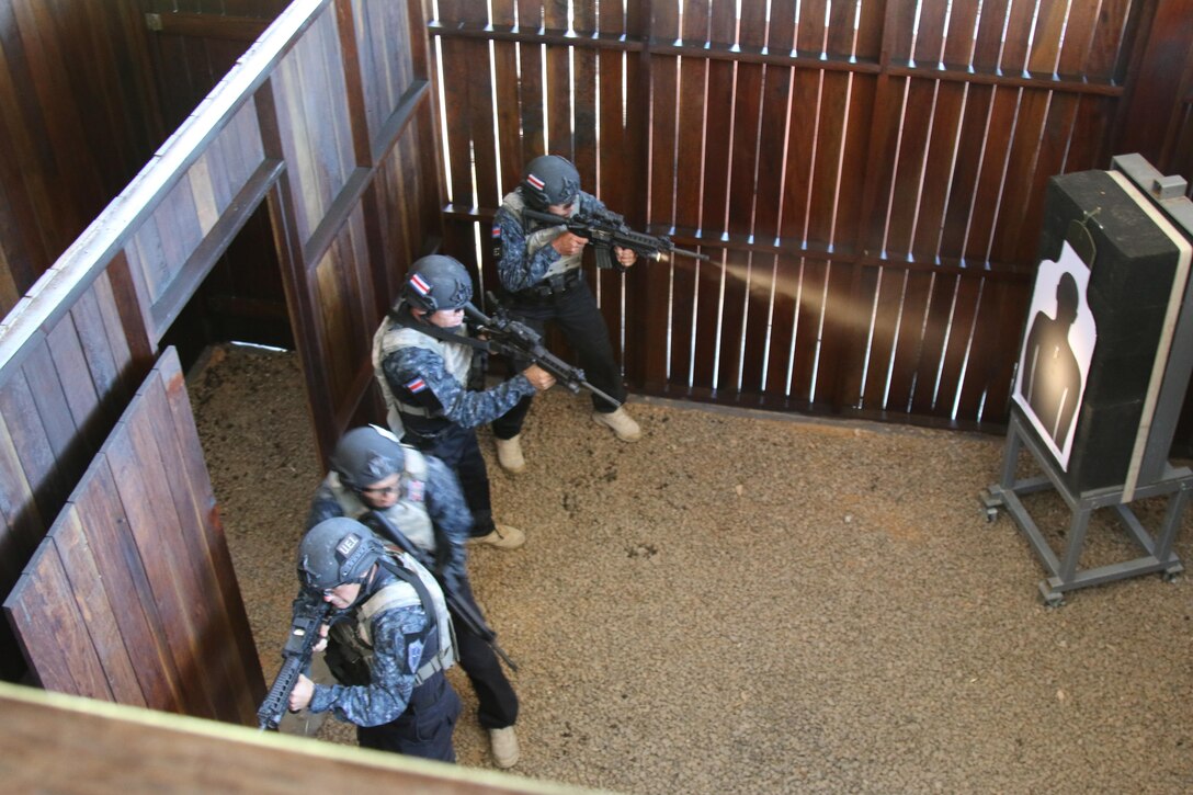 Costa Rican competitors clear a room in a live-fire shoot house July 22, 2017 during a combined assault event at Fuerzas Comando at Cerrito, Paraguay. Competitors in this event attempt to clear a building and rescue a simulated hostage as efficiently as possible. (U.S. Army photo by Sgt. 1st Class James Brown/Released)