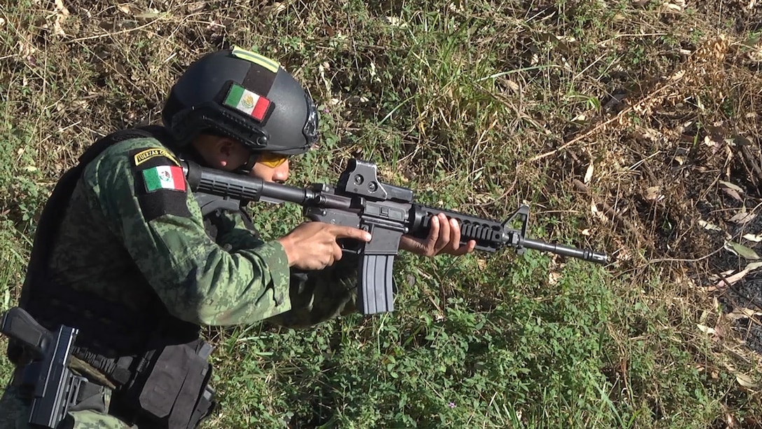 A Mexican competitor aims his weapon to prepare for a combined assault event July 22, 2017, during Fuerzas Comando in Cerrito, Paraguay. There are 20 teams competing in Fuerzas Comando that share a longstanding history of cooperation. (U.S. Army photo illustration by Pfc. Lauren Sam/Released) (This image was created by capturing a still frame from a video.)