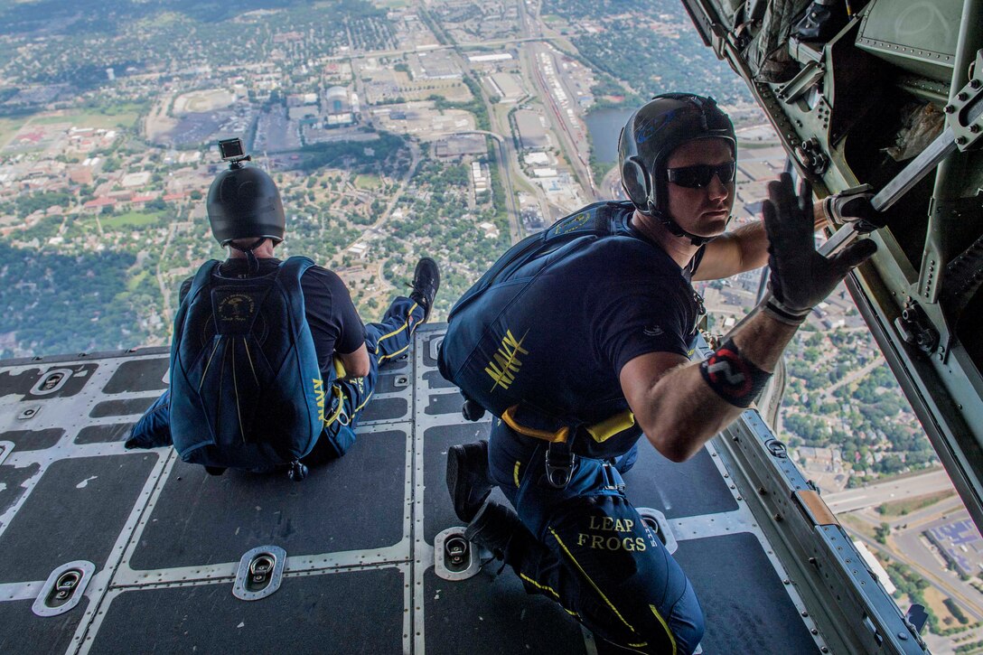 Navy Petty Officer 1st Class Brandon Peterson, a member of U.S. Navy Parachute Team “The Leap Frogs,” signals the aircrew as the team prepares to jump from a C-130 Hercules aircraft during a skydiving demonstration at the Summer X Games in Minneapolis, July 15, 2017. Peterson is a Special Warfare Operator. Navy photo by Petty Officer 3rd Class Kelsey L. Adams