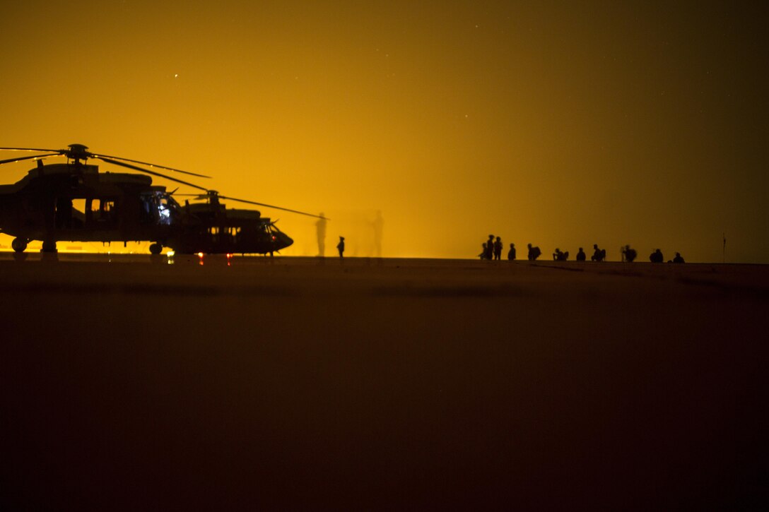 Spanish soldiers wait in front of AS532 Cougar aircraft to begin a battalion air assault exercise with U.S. Marines from Special Purpose Marine Air-Ground Task Force-Crisis Response-Africa at Villanubla Air Base, Spain, June 21, 2017. SPMAGTF-CR-AF deployed to conduct limited crisis response and theater security operations in Europe and North Africa. (U.S. Marine Corps Photo by Cpl. Jodson B. Graves)