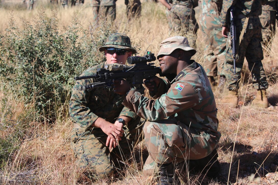 U.S. Marine LCpl. David B. Serge instructs a member of the South African Navy’s Maritime Reaction Squadron (MRS) on proper weapon handling procedures of the U.S. M27 Infantry Automatic Rifle during a familiarization fire range as part of Shared Accord 17 (SA17) at South African Army Combat Training Center, Lohatla, South Africa, July 19, 2017. During SA17 members of the MRS and U.S. Marines will form integrated units, building interoperability as they learn each others techniques, tactics, and procedures. SA17 is a Joint bi-lateral Field Training Exercise with our South African partners focused on Peace Keeping Operations designed to exercise participants’ capability and capacity to conduct African Union / United Nations mandated Peace Keeping Operations.