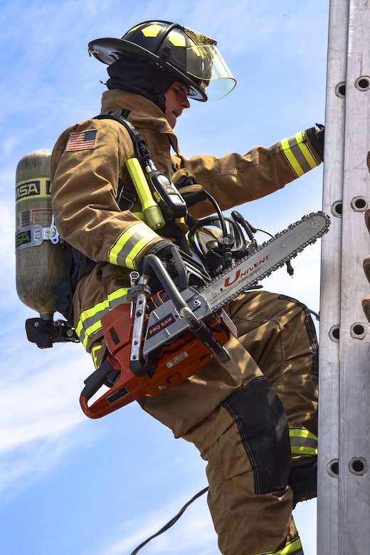 Airman 1st Class Adam Striejewske, 99th Civil Engineer Squadron firefighter, climbs a ladder during Red Flag 17-3 at Nellis Air Force Base, Nev., July 18, 2017. First responders climb ladders to reach the roof of a building and create holes during fires to help smoke easily escape the building. (U.S. Air Force photo by Airman 1st Class Andrew D. Sarver/Released)
