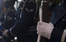 U.S. Air Force Airman 1st Class Alexander Rothrock, Ramstein Base Honor Guardsman and 86th Communications Squadron client systems technician, holds a rifle while participating in a posting of the colors ceremony alongside other honor guardsmen during a change of command ceremony on Ramstein Air Base, Germany, July 20, 2017. The Ramstein Honor Guard can post the colors, pre-post, carry out two-man and six-man flag folds, and execute rifle movements during a number of ceremonies. (U.S. Air Force photo by Senior Airman Tryphena Mayhugh)