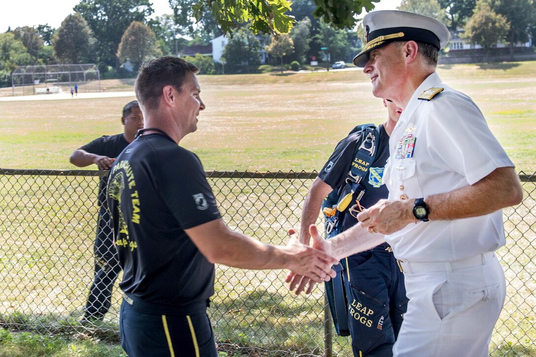 Navy Rear Adm. Frederick J. “Fritz” Roegge, right, commander, Submarine Force, U.S. Pacific Fleet, interacts with members of the U.S. Navy Parachute Team “The Leap Frogs,” after a skydiving demonstration at Hazel Park during Minneapolis/St. Paul Navy Week in Minneapolis, July 17, 2017. Navy photo by Petty Officer 3rd Class Kelsey L. Adams