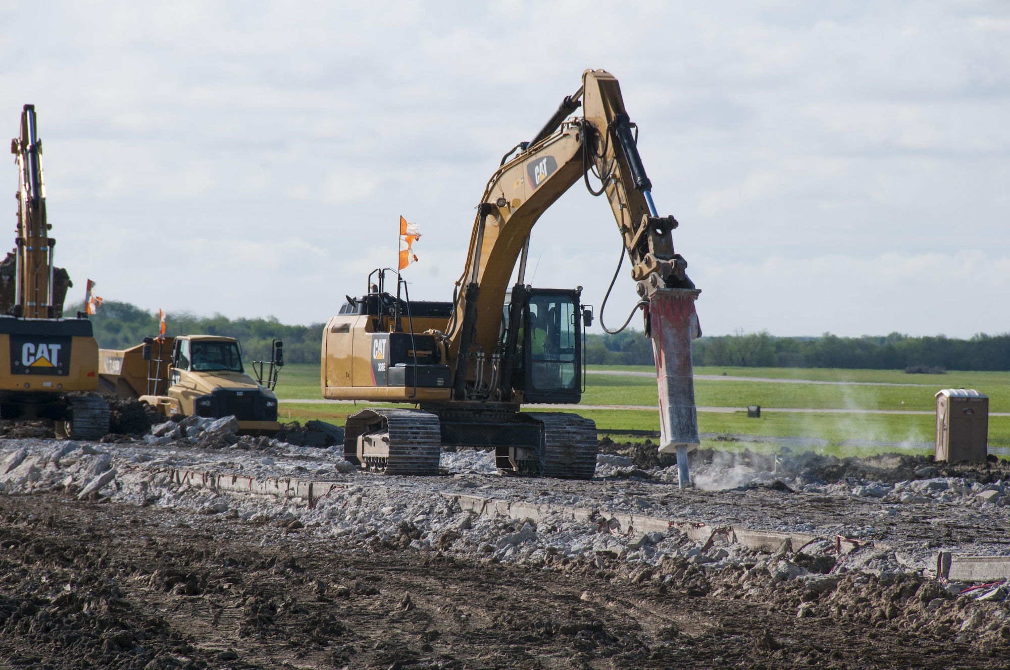 Construction vehicles break apart concrete at the demolition zone on the northwest half of the runway at Forbes Field Air National Guard Base, Topeka, Kan. April 20, 2017. Since February 2017, Forbes Field and local contractors have been performing a major construction overhaul on the runway to improve flight operations and ensure the safety of Airmen and aircraft alike. 