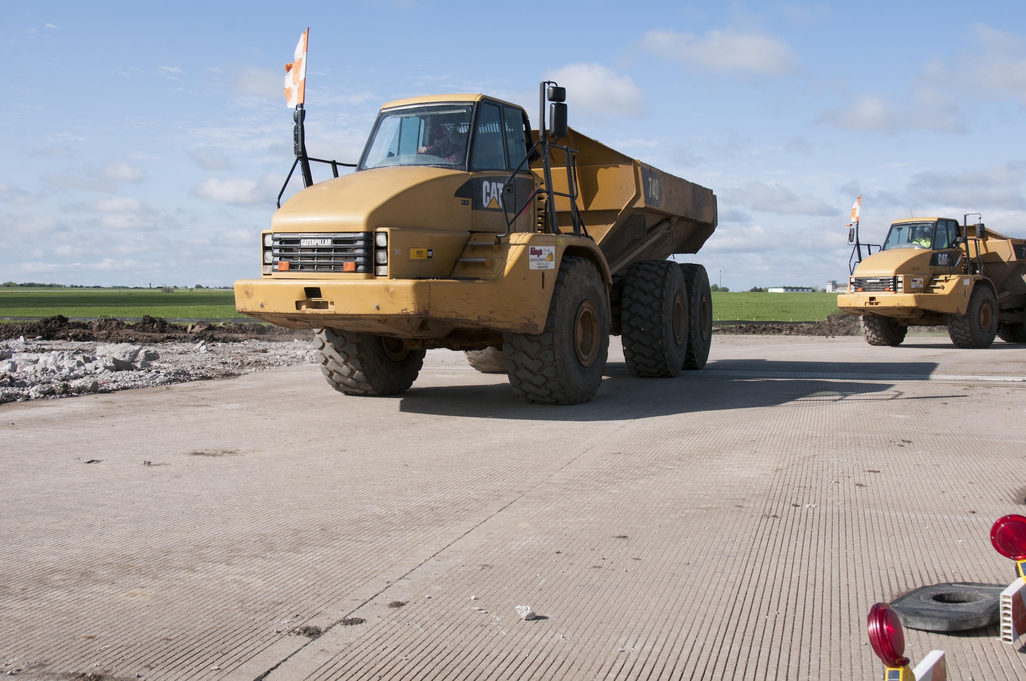 Construction vehicles move concrete away from the demolition zone on the northwest half of the runway at Forbes Field Air National Guard Base, Topeka, Kan. April 20, 2017. Since February 2017, Forbes Field and local contractors have been performing a major construction overhaul on the runway to improve flight operations and ensure the safety of Airmen and aircraft alike. 