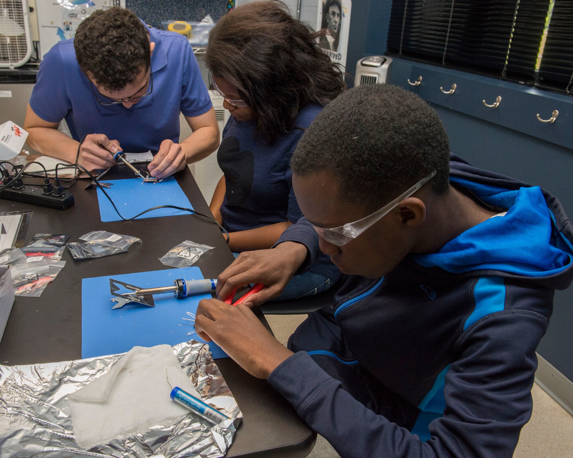 Zachary Belateche (left), Air Force Research Laboratory Pathways student intern and STARBASE students, Jalyn Clayton (middle) and Ja’mil Cantrell, build drones during LEGACY Craftsman Camp inside the STARBASE Wright-Patt facility, Dayton, Ohio, June 28, 2017. The LEGACY team work with students to find the college path that best suits their lifestyle and future STEM career. (U.S. Air Force photo/Michelle Gigante)