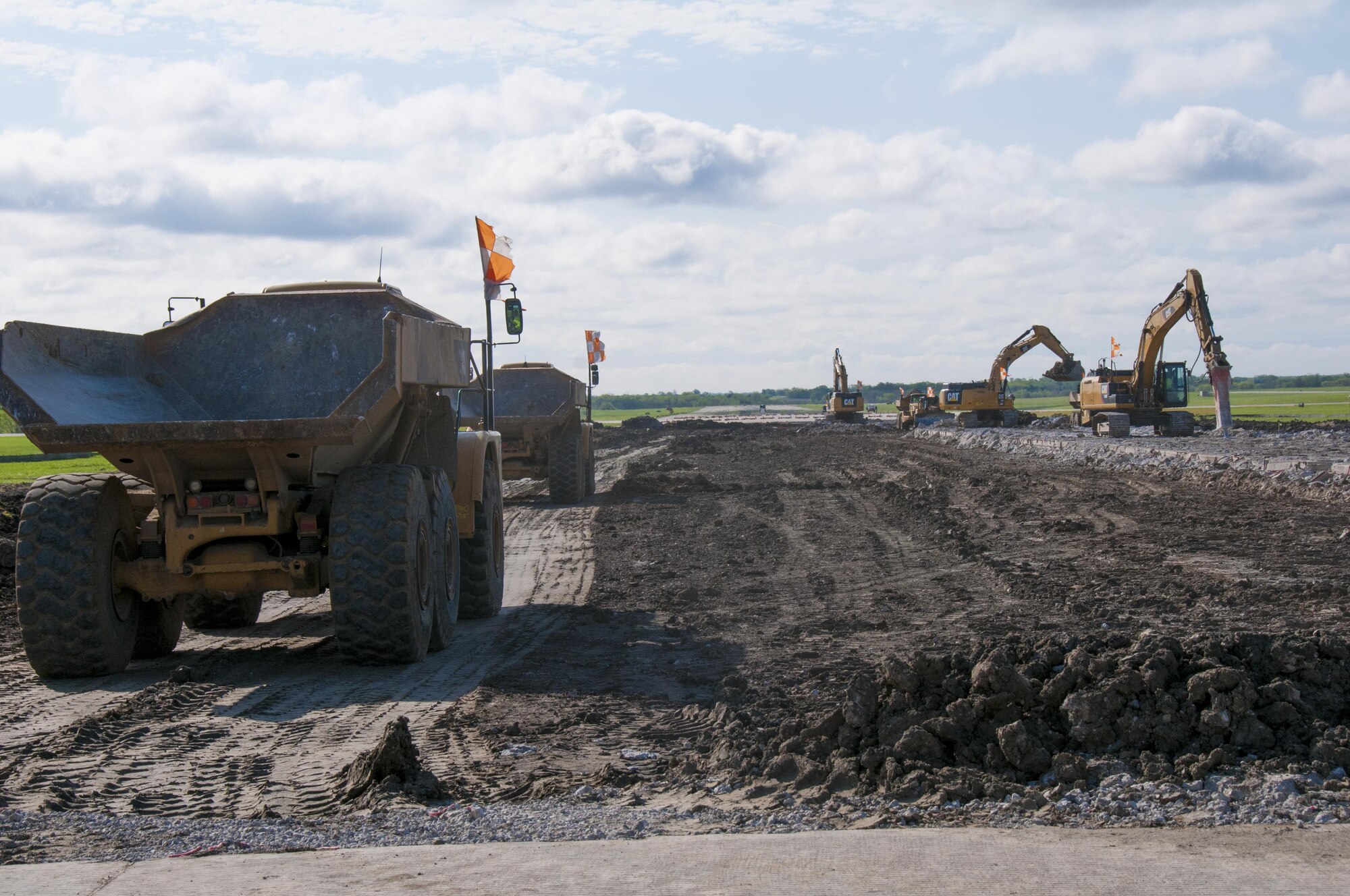 Construction vehicles move concrete away from the demolition zone on the northwest half of the runway at Forbes Field Air National Guard Base, Topeka, Kan. April 20, 2017. Since February 2017, Forbes Field and local contractors have been performing a major construction overhaul on the runway to improve flight operations and ensure the safety of Airmen and aircraft alike.