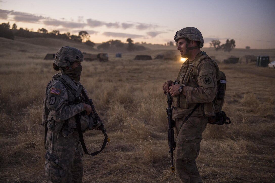 Cpl. Vanessa Lebold and Spc. Jasper Devin, U.S. Army Reserve Soldiers with the 56th Military Police Company, of Mesa, Arizona, talk after a reconnaissance patrol at a Combat Support Training Exercise (CSTX) at Fort Hunter Liggett, California, July 22, 2017. (U.S. Army Reserve photo by Master Sgt. Michel Sauret)