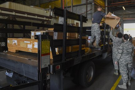 Senior Airman Matt Kolodziej, 628th Logistics Readiness Squadron Materiel Management Flight individual protective equipment section operator, stores tactical equipment in the materiel management building on Joint Base Charleston, S.C., July 14. IPE issues equipment to members of Joint Base Charleston who are preparing to deploy.