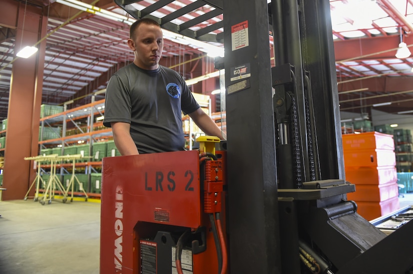 Senior Airman Matt Kolodziej, 628th Logistics Readiness Squadron Materiel Management Flight individual protective equipment section operator, stores tactical equipment in the materiel management building on Joint Base Charleston, S.C., July 14. IPE issues equipment to members of Joint Base Charleston who are preparing to deploy.