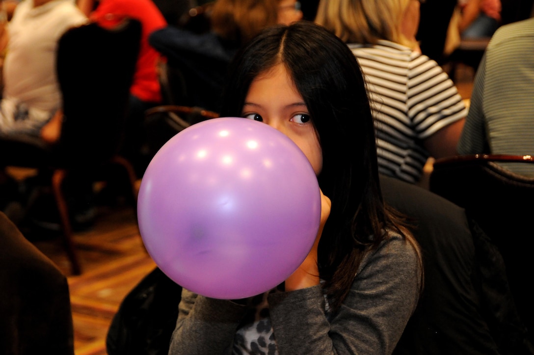 Sophia Flores blows up a balloon July 22 during a 99th Regional Support Command Strong Bonds family event at the Kalahari Resort in Pocono Manor, Pennsylvania.  Strong Bonds is a unit-based, chaplain-led program, which assists commanders in building individual resiliency by strengthening the Army Family. The core mission of the Strong Bonds program is to increase individual Soldier and Family member readiness through relationship education and skills training.