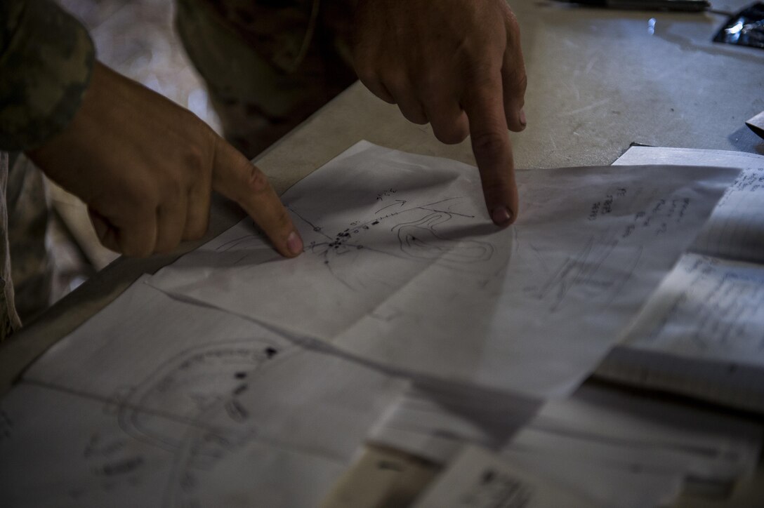 U.S. Army Reserve military police Soldiers from various units point to a hand-drawn map for an upcoming mission during a Combat Support Training Exercise (CSTX) at Fort Hunter Liggett, California, July 22, 2017. (U.S. Army Reserve photo by Master Sgt. Michel Sauret)