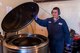 Bryan Schuler, hazardous waste technician, showcases the industrial recycling centrifuge in action. The centrifuge spins absorbent pads at a high rate in order to separate oil from the pads into an exterior container to be consolidated with other barrels of used oil. (U.S. Air Force Photo by Staff Sgt. Charles Dickens/Released)