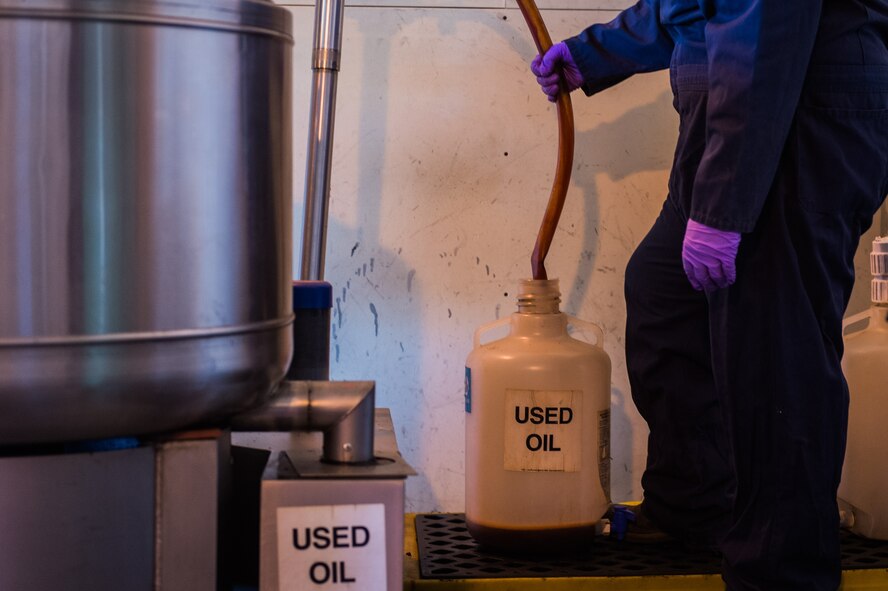 During the centrifugal process, used oil is spun from absorbent pads and collected in an exterior container. Once the oil is separated from the pads, it is consolidated to other barrels of used oil to be prepared for disposal. (U.S. Air Force Photo by Staff Sgt. Charles Dickens/Released)