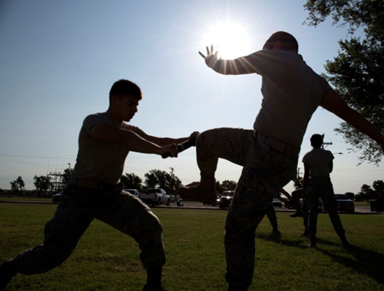 An Airman training to be a 71st Security Forces Squadron augmentee blocks a kick during baton training July 20 at Vance Air Force Base, Oklahoma. Augmentees are trained by 71st SFS “Defenders” to perform security forces’ duties when the squadron needs additional people. (U.S. Air Force photo/ Airman Zachary Heal)