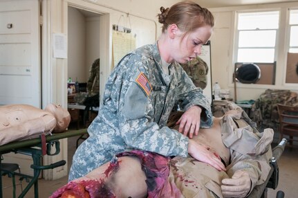 Army Reserve 1st Lt. Rebecca Milligan, of the Effects and Enablers Team, which is augmenting the 84th Training Command's Combat Support Training Exercise and the Army Medical Command’s Global Medic Exercise headquartered out of Fort Hunter Liggett, California, prepares “Trauma Charlie” a simulation injury mannequin used by medical professionals to train on during mass casualty scenarios on Camp Roberts, California, July 16, 2017.