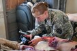 Army Reserve 1st Lt. Rebecca Milligan, of the Effects and Enablers Team, which is augmenting the 84th Training Command's Combat Support Training Exercise and the Army Medical Command’s Global Medic Exercise headquartered out of Fort Hunter Liggett, California, prepares “Trauma Charlie” a simulation injury mannequin used by medical professionals to train on during mass casualty scenarios on Camp Roberts, California, July 16, 2017.