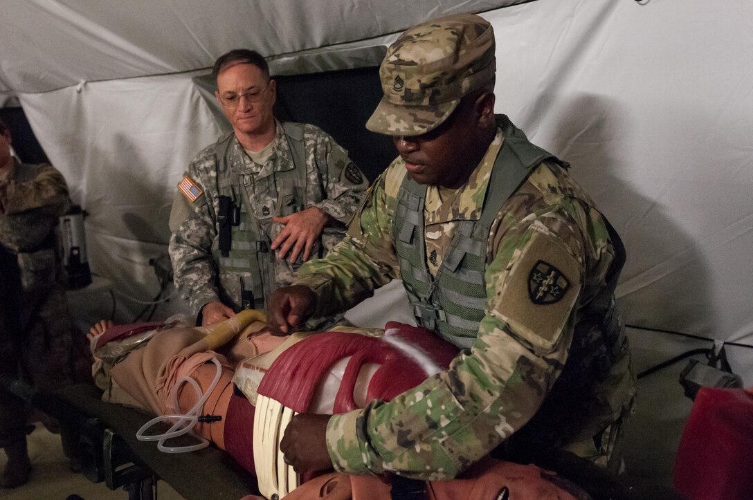 Sgt. 1st Class Terry Warren, of the Effects and Enablers Team, which is augmenting the 84th Training Command's Combat Support Training Exercise and the Army Medical Command’s Global Medic Exercise headquartered out of Fort Hunter Liggett, California, demonstrates a “cut suit,” a surgical suit meant to replicate realistic scenarios for medical professionals to train on during mass casualty exercises on Camp Roberts, California, July 16, 2017.