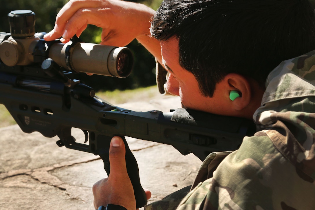 A member of the U.S. special operations team adjusts the scope on his sniper rifle in the field shooting event at Vista Alegre in Villa Hayes, Paraguay, July 19, 2017, part of Fuerzas Commando 2017. The soldiers are Army Green Berets assigned to 7th Special Forces Group, from Eglin Air Force Base, Florida. Army photo by Spc. Elizabeth Williams