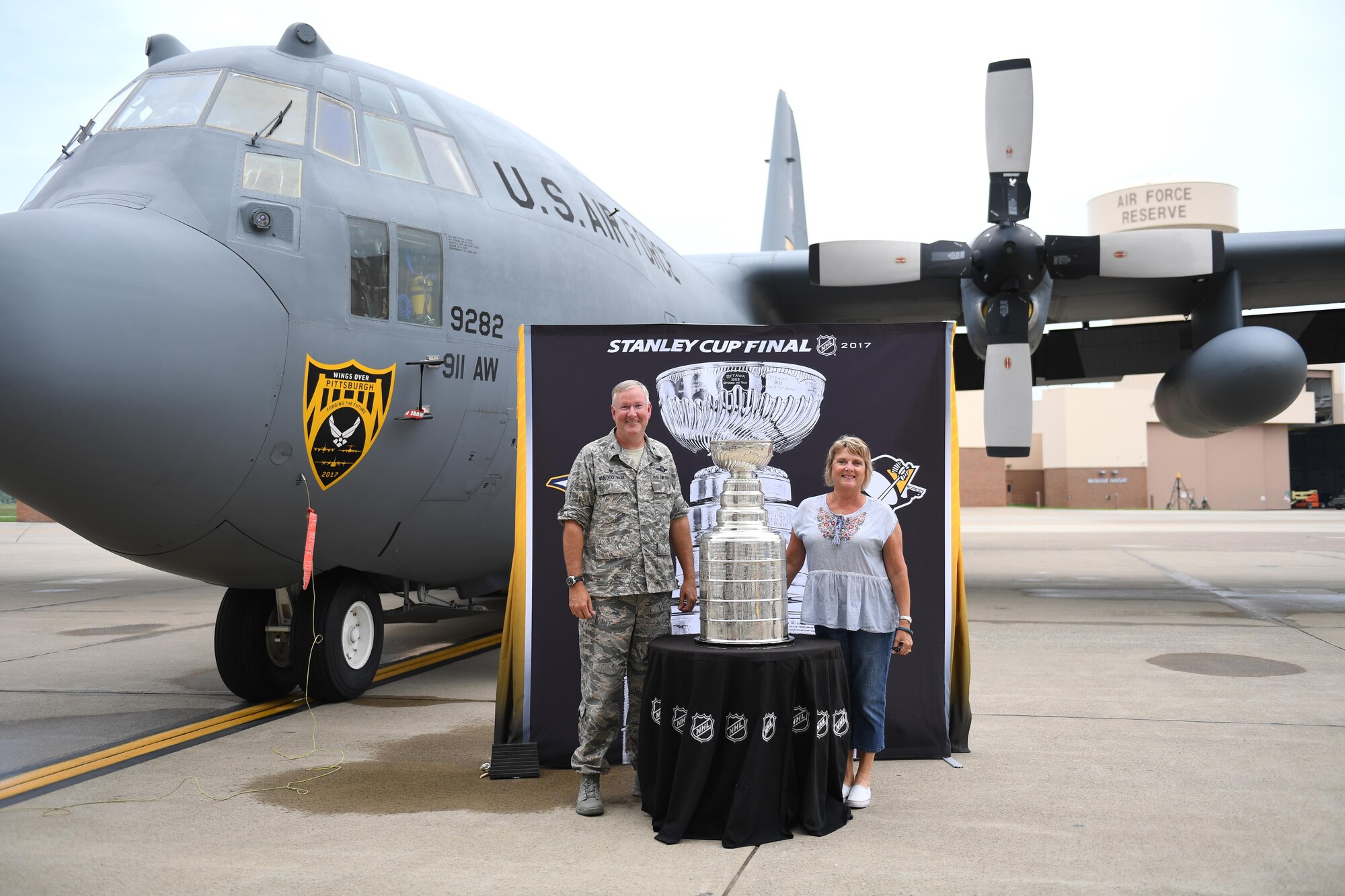 Col. Jeff Van Dootingh, commander of the 911th Airlift Wing, and his wife Diana stand with the Stanley Cup at the Pittsburgh International Airport Air Reserve Station, Pa., July 12, 2017. The Stanley Cup was brought on base by Bill Guerin, assistant general manager of the Pittsburgh Penguins and former Penguins player, for base members to see and be photographed with during his day with the cup following the Penguins’ 2017 Stanley Cup Championship win. (U.S. Air Force photo by Senior Airman Beth Kobily)