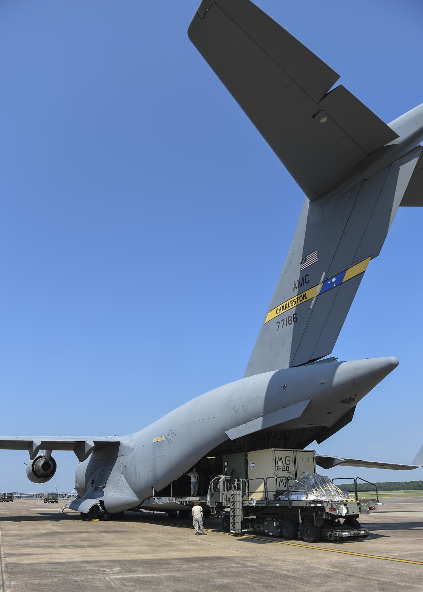 Aerial porters from the 19th Logistics Readiness Squadron load cargo onto a C-17 Globemaster from Joint Base Charleston, S.C. July 23, 2017, at Little Rock Air Force Base, Ark. Little Rock Airmen plan to join more than 3,000 Air Force and joint service members, alongside 25 international partners, to train together during Mobility Guardian 2017. (U.S. Air Force photo by Staff Sgt. Harry Brexel)