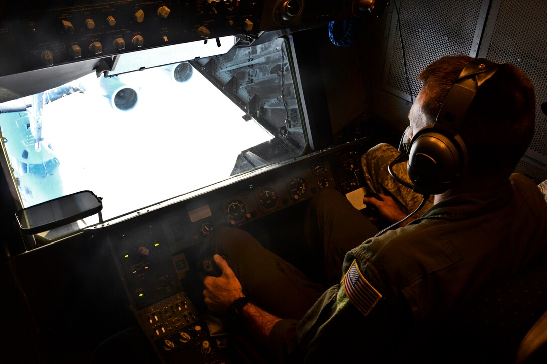 Air Force Tech. Sgt. Daniel Flenniken refuels a C-17 Globemaster III over the Pacific Ocean, July 13, 2017. Flenniken is a boom operator assigned to the 6th Air Refueling Squadron from Travis Air Force Base, California. Three KC-10s from Travis Air Force Base and Joint Base McGuire-Dix-Lakehurst, New Jersey, refueled five C-17s carrying more than 300 coalition paratroopers. The C-17s went on to conduct a strategic air drop over Australia in support of Exercise Talisman Saber 2017. Air Force photo by 2nd Lt. Sarah Johnson