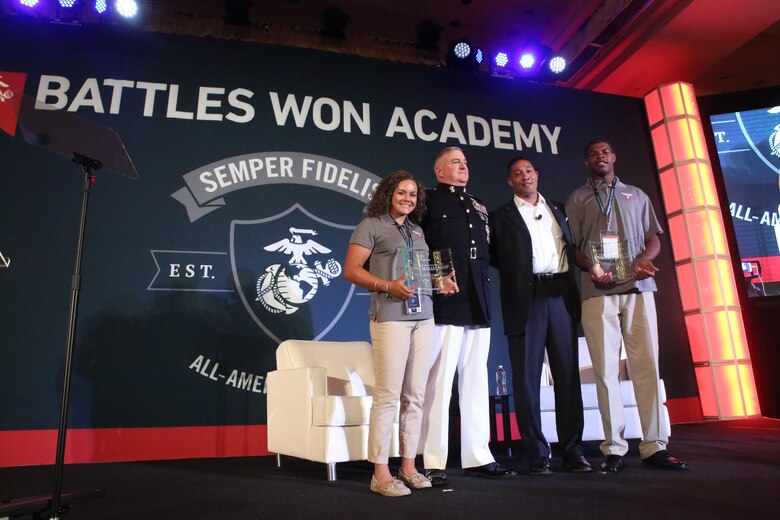 Gen. Glenn M. Walters, the assistant commandant of the Marine Corps, and Verice Bennet, the senior personnel management consultant for the Marine Corps, present Juvia Davis and LaMarcus Strickland with the “Exceptional Leadership Award” during the closing ceremonies of the Battles Won Academy in Washington D.C., July 16, 2017. The Battles Won Academy is a part of the Marine Corps’ Semper Fidelis All-American Program, which recognizes young men and women who excel in athletics, but have also shown themselves to be leaders in the classroom and in their hometowns. Ninety-seven high school student-athletes attended the academy, which focused on developing their self-confidence, discipline, teamwork, and honing the fighting spirit that embodies the Marine Corps. (U.S. Marine Corps photo by Sgt. Bryan Nygaard/Released)