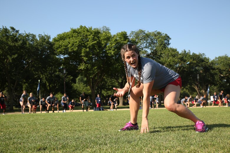 Adeline Gray, three-time United States World Champion Wrestler, demonstrates warm-up exercises during a physical training session in Washington D.C. during the inaugural Battles Won Academy, July 16, 2017. The Battles Won Academy is a part of the Marine Corps’ Semper Fidelis All-American Program, which recognizes young men and women who excel in athletics, but have also shown themselves to be leaders in the classroom and in their hometowns. Ninety-seven high school student-athletes attended the academy, which focused on developing their self-confidence, discipline, teamwork, and honing the fighting spirit that embodies the Marine Corps. (U.S. Marine Corps photo by Sgt. Bryan Nygaard/Released)