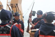 BM2 Jim Bowell instructs HEALY crewmembers on the use of the Shoulder Line Throwing Gun.