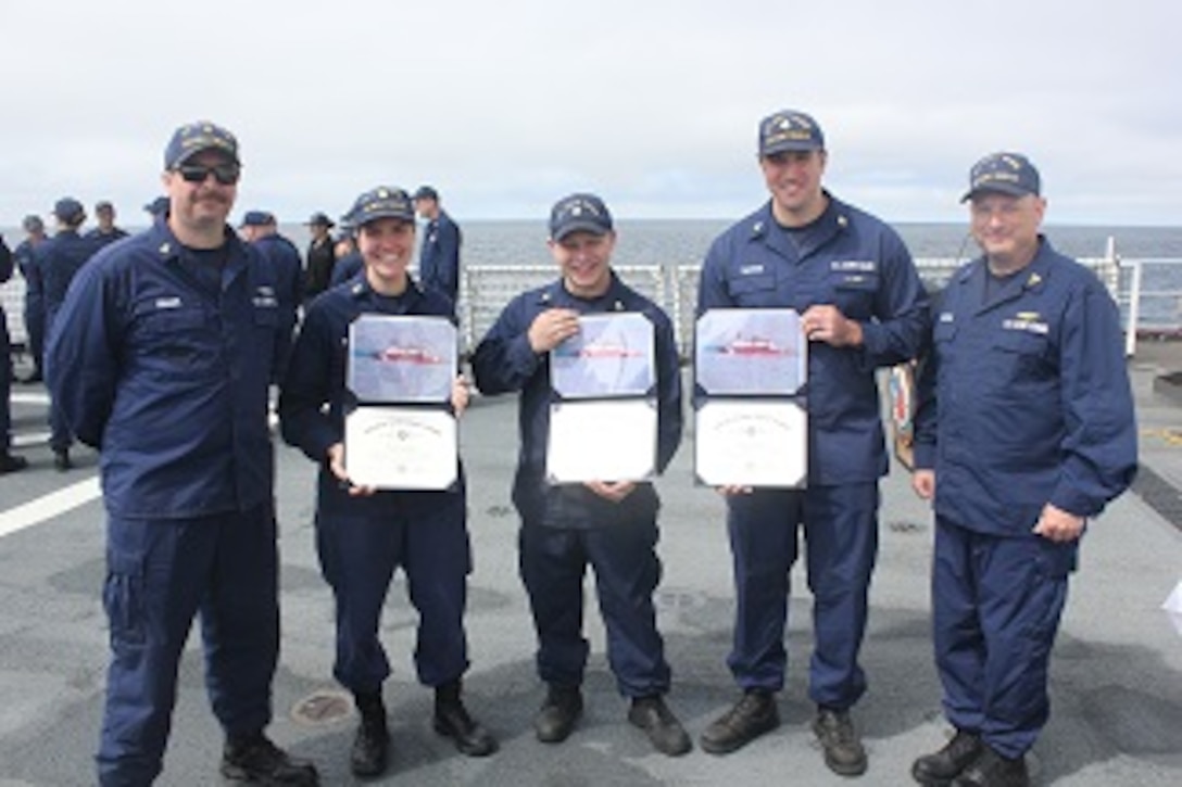 HEALY’s Gold and Silver Ancient Mariners, ENG3 Rob Kopser and FSCS Cliff Grader stand with newly minted permanent cuttermen.
