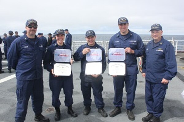 HEALY’s Gold and Silver Ancient Mariners, ENG3 Rob Kopser and FSCS Cliff Grader stand with newly minted permanent cuttermen.